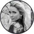 A black and white profile picture of the influencer @nakedwriting. She has long hair and looks back over her shoulder at the camera.